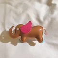 Detail view of a handcrafted brown leather elephant pendant with pink wings and blue feet - Back Clip Only / Brown