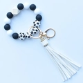 Detail of leopard print silicone beads bracelet with wood bead and white PU tassel - Black & White