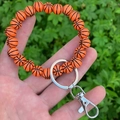 Detail of orange basketball beaded keychain bracelet with silver metal ring and clasp - Orange Basketball