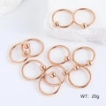 Set of 10 rose gold stainless steel ball closure rings displayed on white textured stone - Rose Gold (Pack of 10)