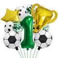 Close-up of golden champion trophy balloon and green number one balloon for party decoration - Soccer Set Number 1