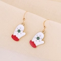 Detail of gold metal Christmas glove earrings with white enamel and green snowflake patterns - Christmas Mitten