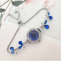Elegant silver leaf watch with blue dial and clover crystal charms on a floral background - Blue