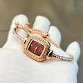 Detail of rose gold square watch with red dial and crystal bracelet on a gloved hand - Red