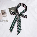 Long skinny silk scarf with green and black geometric stripes tied in a bow - Green Pink Arrow