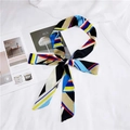 Polka dot skinny silk scarf styled as a bow on a white cloth and magazine - Multi-Color Stripes Blue Black