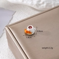 Macro shot of 1.4cm mini resin coffee cup and croissant model on champagne silk - Coffee Cup