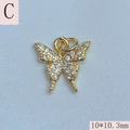 Macro detail of a 10x10.3mm gold butterfly pendant with sparkling cubic zirconia stones - Butterfly C - Clear Zircon / 10*10.3mm