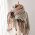 Detail of soft gradient tassel scarf in beige and green on a mannequin with a coat - Khaki Beige Green Gradient