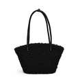 Close-up of black fleece tote bag showing plush lamb wool texture and leather straps - Black