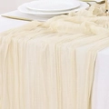 Elegant cream crinkle gauze table runner draped over a minimalist wedding reception setting - Off White