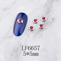 Macro detail of 5x5mm silver flower nail charms with red rhinestones on blue nails - Silver Five-Petal Flower Red Rhinestone (6657)
