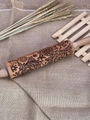 Macro detail of laser-engraved floral and snowflake patterns on a wooden rolling pin - Large Vine Flower