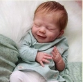 20 inch reborn baby doll with red hair and green floral outfit sleeping on white rug - Red Short Hair Style / Normal Painted Cloth Body