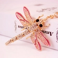 Golden dragonfly keychain with pink crystals on a book spine, elegant accessory for women - Pink