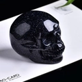 Handcrafted blue sandstone skull sculpture with shimmering crystals on a white card - Blue Goldstone Skull-1.5 Inches