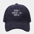 Navy corduroy baseball cap with 'Don't Forget To Smile' white embroidery on a gray background - Adjustable / Navy Blue
