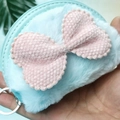 Close-up of light blue plush coin purse featuring a pink bow and silver metal keychain - Butterfly Style-Blue Edging