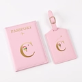 Detailed close-up of pink PU leather passport cover and luggage tag with gold hot stamping - Pink Letter C