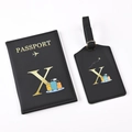 Close-up of black PU leather passport holder and luggage tag set with golden letter X - Black Letter X