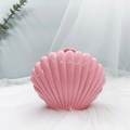 Detail of pink shell-shaped jewelry box with glossy finish on soft faux fur background - Pink