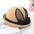Camel felt bowler hat for women with black mesh bunny ears and bow on a white desk - Camel