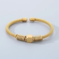 Braided gold stainless steel cable bracelet with geometric bead and spiral accents - Style B Cube Bead With Spring Decoration / Gold