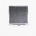 Detailed close-up of a square folding makeup mirror with a black textured dotted cover - Black