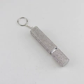 Detailed macro view of a silver rhinestone studded 10ml portable perfume spray bottle - White