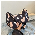 Detail view of the black crescent shoulder bag with cute brown bear and bow print details - Black