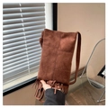 Detail of dark brown suede crossbody bag featuring bohemian fringe and stitched seams - Coffee
