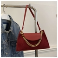 Macro view of burgundy corduroy crossbody bag with vintage gold chain and leather strap - Red