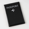 Classic black faux leather passport cover with white plane icon and text on white background - Black
