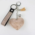 Sparkling diamond heart keychain with rose gold fringe and leather strap on white background - Champagne
