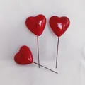 Three red heart foam cake toppers and floral picks on white textured fabric background - 50mm (Single)