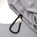 Close-up of elegant polished black and white crystal beaded phone chain with durable loop - Phone Chain / Black Striped Stone + White Jade Bodhi (K3403)
