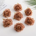 Close-up of vintage dusty pink artificial silk rose heads for wedding floral arrangements - Khaki