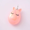 Detailed view of a pink unicorn-shaped container with a silver horn and eyelash design - Iridescent Lotus Pink