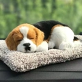 Realistic sleeping tricolor beagle plush toy on a soft beige mat with a natural background - Large Beagle Dog