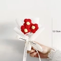 Close-up of handmade red knitted mini flower bouquet wrapped in white paper, 12-15cm height - Mini 3 Red Flowers