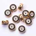 Detailed macro shot of golden alloy evil eye charms for DIY jewelry bracelet making - Black