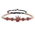Detail of rose gold beaded bracelet featuring a pink zircon crown and adjustable black cord - Rose Gold Rose Red Zircon Crown Bracelet