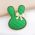 Detail of green rabbit charm with quilted texture and gold metallic bow detail - Vibrant Green
