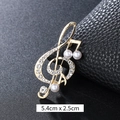 Elegant gold-tone musical note brooch with pearls and rhinestones on black background - Three-Pearl Music Note Gold (XD9420)