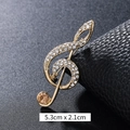 Golden treble clef brooch with white crystals and amber gemstone on black leather - Champagne Rhinestone Treble Clef Gold (XD9424)