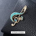 Lussuosa spilla a chiave di violino dorata con brillanti strass blu cielo - Chiave di Violino Strass Blu Chiaro Oro (XD9426)