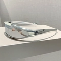 Close-up of futuristic silver wrap-around sunglasses with metallic finish and sleek lens - Electroplated Silver Frame Silver Mirror Lens