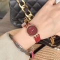 Elegant gold watch with red leather strap and minimalist dial worn by a model - Gold/Red (Round Melody Style)