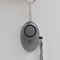 Grey personal alarm keychain with speaker and grey lanyard in an oval minimalist design - Gray