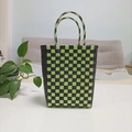Detail of green and black checkered hand-woven plastic bucket bag with dual handles - Large / Dark Green